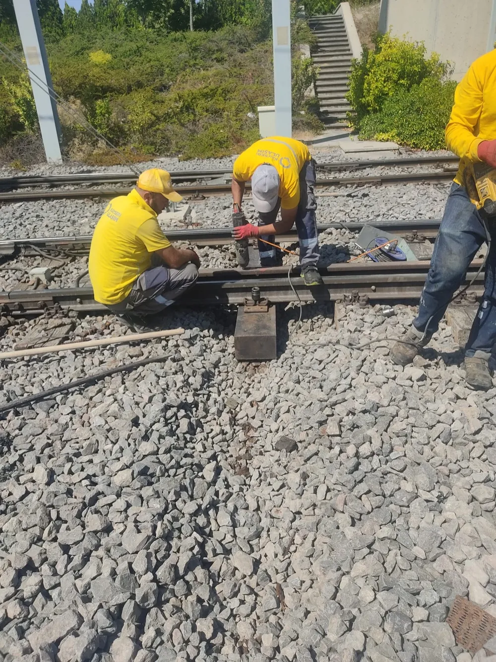 Track crew drilling a coach-screw hole