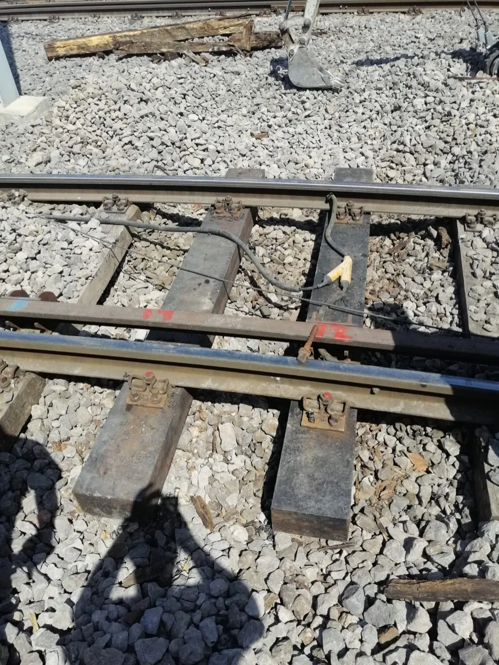 Composite sleepers beneath the rail, coach-screw fastenings, close-up